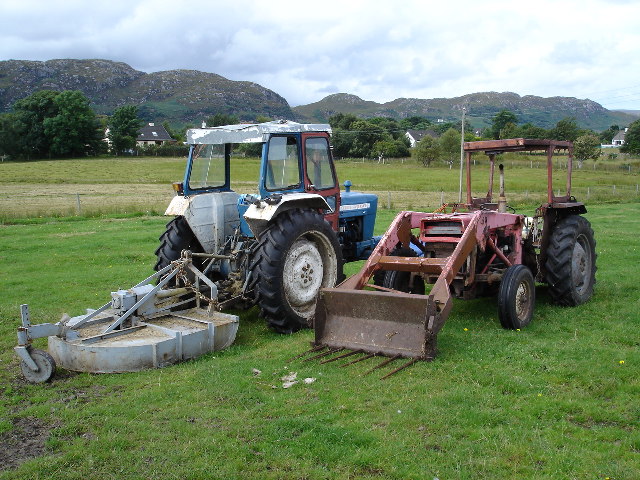 tractors with farm implements in field